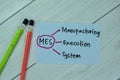 Concept of MES - Manufacturing Execution System write on sticky notes isolated on Wooden Table