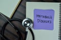 Concept of Metabolic Diseases write on sticky notes with stethoscope isolated on Wooden Table