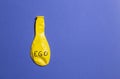 Concept and metaphor of deflated ego. yellow and blue. copy space