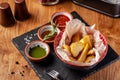 The concept of Mexican cuisine. Baked spicy potatoes with pepper, with different sauces, salsa, guacamole, chilli and shrimp. Royalty Free Stock Photo