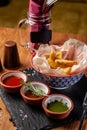 The concept of Mexican cuisine. Baked spicy potatoes with pepper, with different sauces, salsa, guacamole, chilli and shrimp. Royalty Free Stock Photo