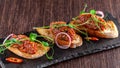 The concept of Mexican cuisine. Beef tartare with parsley, French mustard beans on baguette croutons. A dish in the restaurant