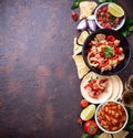 Concept of Mexican food. Salsa, tortilla, beans, fajitas and te