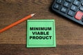 Concept of Minimum Viable Product write on sticky notes isolated on Wooden Table Royalty Free Stock Photo