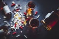 Concept of mixing alcohol and prescription pills, vertical view.