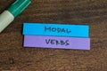 Concept of Modal Verbs write on sticky notes  on Wooden Table Royalty Free Stock Photo