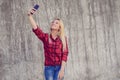 Concept of modern technology in modern life. Young happy girl taking making self selfie phoyo photographing picture on cell phone Royalty Free Stock Photo