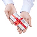 Concept, money as a gift. Man`s with both hands in shirt takes or gives pile of 100 dollar bills tied with red ribbon with bow. Royalty Free Stock Photo