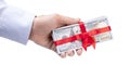 Concept, money as a gift, win or bonus. Man`s hand in shirt takes or gives pile of 100 dollar bills tied with red ribbon with bow Royalty Free Stock Photo