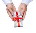 Concept, money as a gift, win or bonus. Man`s hand in shirt takes or gives pile of 100 dollar bills tied with red ribbon with bow Royalty Free Stock Photo
