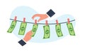Concept of money laundering, hands picking dried dollar bills off clothesline. Financial crime washing currency. People Royalty Free Stock Photo