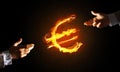 Concept of money making with euro currency fire symbol on dark background