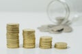 Stacked coins with jar. Royalty Free Stock Photo