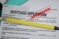 Concept of mortgage application approved form write on document isolated on Wooden Table Royalty Free Stock Photo