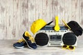 The concept of the music Hip hop style.Vintage audio player with headphones,fashionable cap, sneakers and sunglasses. Royalty Free Stock Photo