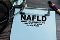 Concept of NAFLD - Non-Alcoholic Fatty Liver Disease write on paperwork isolated on wooden background