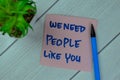 Concept of We Need People Like You write on sticky notes isolated on Wooden Table