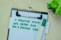 Concept of A Negative Mind Will Never Give You A Positive Life write on sticky notes isolated on Wooden Table