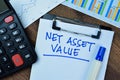 Concept of Net Asset Value write on paperwork isolated on Wooden Table Royalty Free Stock Photo