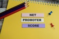 Concept of Net Promoter Score write on sticky notes isolated on Wooden Table