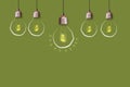 Concept of new ideas and creative solutions. Glowing light bulb on a green background. Copy space Royalty Free Stock Photo