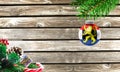 Concept of New Year and Christmas, on a wooden background, Christmas tree branches and a Christmas toy with the flag of Benelux