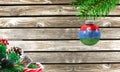 Concept of New Year and Christmas, on a wooden background, Christmas tree branches and a Christmas toy with the flag of Karelia