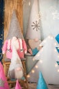 The concept of the New Year holidays. Many dwarfs with Christmas trees in a decorated Christmas room close-up and copy space