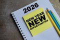 Concept of new year opportunities in 2026 write on sticky notes isolated on Wooden Table Royalty Free Stock Photo