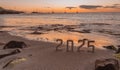 Concept of new year 2025 with sunrise on the beach.