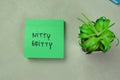 Concept of Nitty Gritty write on sticky notes isolated on Wooden Table Royalty Free Stock Photo