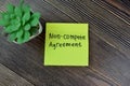 Concept of Non-Compete Agreement write on sticky notes isolated on Wooden Table
