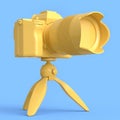 Concept of nonexistent DSLR camera with tripod isolated on blue monochrome Royalty Free Stock Photo