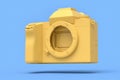 Concept of nonexistent gold DSLR camera isolated on blue monochrome background. Royalty Free Stock Photo