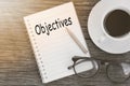 Concept Objectives message on notebook with glasses, pencil and