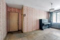 Old ugly abandoned unfurnished room with a dusty black piano