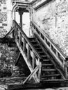 Concept of old black and white photo of wooden stairs in abandoned castle. Royalty Free Stock Photo