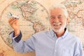 Concept of old senior people and travel lifestyle - wanderlust with no limit age and caucasian man portrait with world map in Royalty Free Stock Photo