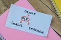 Concept of OLE - Object Linking Embedding write on sticky notes isolated on Wooden Table
