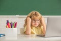 concept of online education. nerd kid in glasses with laptop. september 1. e-learning Royalty Free Stock Photo