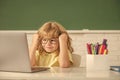concept of online education. nerd kid in glasses with laptop. september 1. e-learning Royalty Free Stock Photo