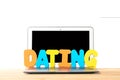 Concept for online internet dating. Modern laptop with dating work from colorful letters against white isolated background Royalty Free Stock Photo