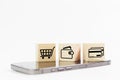 Concept of online shopping. wooden cube blocks with shopping or e-commerce icons on smartphone with white background. business Royalty Free Stock Photo