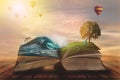 Concept of an open magic book; open pages with ocean and land and small child. Fantasy, nature or learning concept, with copy Royalty Free Stock Photo