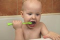 The boy is brushing his teeth in the bathroom. Teething. The concept of oral hygiene