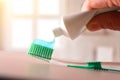 Concept oral hygiene with hand putting toothpaste on toothbrush Royalty Free Stock Photo