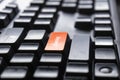 The concept of the orange button on the computer that is design to enter a searching key font on a black PC keyboard for office Royalty Free Stock Photo