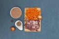 The concept of oriental cuisine. Ingredients for national Uzbek pilaf with meat on a blue table. Background image, top view, flat Royalty Free Stock Photo