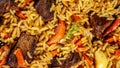 The concept of oriental cuisine. Texture of Uzbek pilaf with meat, vegan pilaf. top view