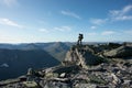 The concept of outdoor activities in the mountains. Man traveler on a background of mountains. Atmospheric view of the snowy slope